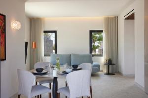 a dining room with a table and chairs at Aernia Suites & Art in Akrotiri