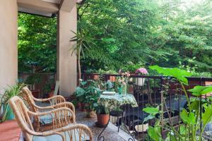 a patio with two chairs and a table and plants at Al Quadrifoglio Bed & Breakfast in Verona