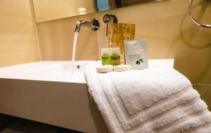 a bathroom with a sink and a towel and a blender at La MOONte in Păltiniş