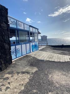 a building on a pier next to the water at Volcano View in El Golfo