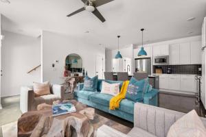 a living room with a blue couch and a kitchen at Myrtle C in Nashville