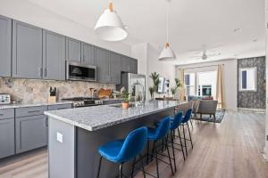 a kitchen with a large island with blue bar stools at Harmony 17 in Nashville