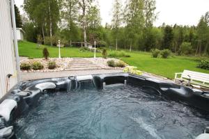 a large pool of water in a yard at Big house with jacuzzi by the forrest in Hudiksvall