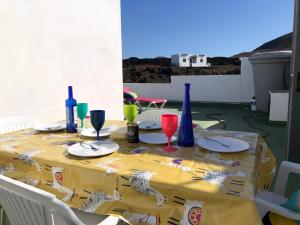 une table avec un tissu de table jaune sur une terrasse dans l'établissement Volcano View, à El Golfo