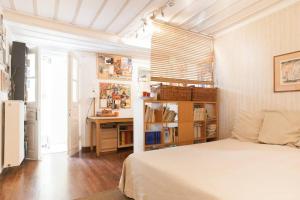 a bedroom with a bed and a desk in it at At the foot of Acropolis. in Athens