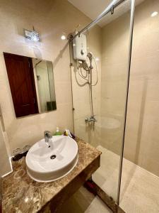 胡志明市的住宿－Teddy Apartment at Sky Center Luxury，一间带水槽和淋浴的浴室