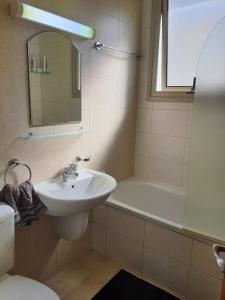 a bathroom with a sink and a bath tub at Yama's Villa - Polyxenia luxury, protaras, cyprus in Protaras