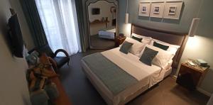 a bedroom with a large bed and a mirror at Jacona 365 in Palermo