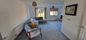 a living room with a couch and a chair at Cashel on the Coast, 3 bedroom holiday home, Ballycastle in Ballycastle