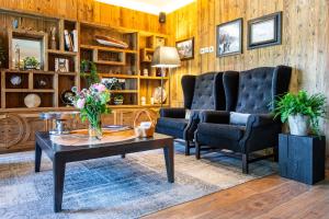 a living room with a couch and a table at Hotel Montchalet in Ortisei