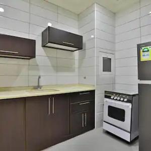 a kitchen with a sink and a stove at الحريرة in Jeddah