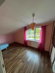 an empty room with a bed and a window at Soo Rendimaja in Võru