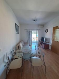 a dining room with a glass table and chairs at Apartments Ostojic in Tučepi