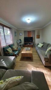 a living room with a couch and a coffee table at Abbey Beach Shack in Busselton