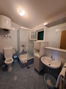 a bathroom with a toilet and a sink and a shower at Apartments Ostojic in Tučepi +51 photos