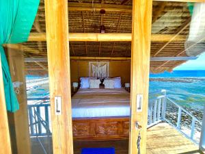 a bedroom with a bed in a room with the ocean at Coastal Inn in Nusa Penida