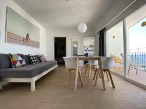 a living room with a couch and a table at Hotel Cenit & Apts. Sol y Viento in Ibiza Town