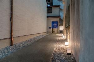 an empty hallway with lights on the side of a building at 彩ホテル 紺 in Fukuoka