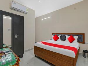 a bedroom with a large bed with red pillows at OYO Flagship 81216 Hotel Silver Grand in Lucknow