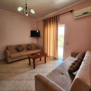 a living room with a couch and a table at Amelia Apartments in Ksamil