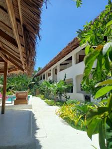 a resort with a pathway and a building at Parrots Boutique Resort in San Vicente