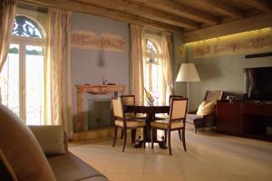 a living room with a dining room table and chairs at Verona Luxury Flats , Piazza Erbe with balcony on main square in Verona