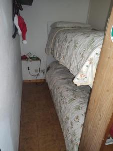 a bed in a small room with a santa hat on it at appartamento Cima in Fiumalbo