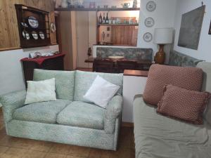 a living room with a couch and a chair at appartamento Cima in Fiumalbo