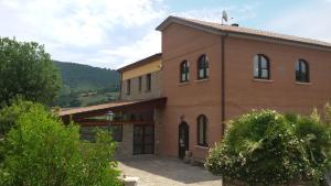 a large brown brick building with a garage at Il Molino Della Contessa in Castelmezzano