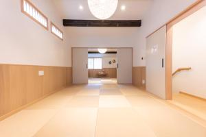 an empty hallway in a building with a large ceiling at Irodori Hotel SAKURA in Fukuoka