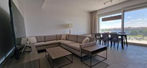 a living room with a couch and a dining room at iComfort Aparthotel in Timişoara