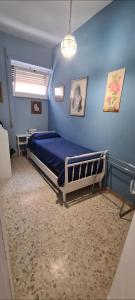 a bedroom with a bed in a blue wall at Home Rome Center in Rome