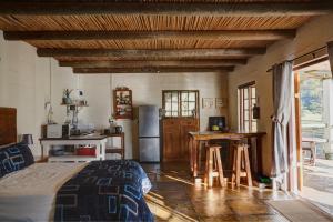 a kitchen with a bed and a table in a room at Somerset Gift Getaway Farm in Swellendam