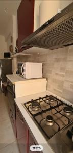 a stove top in a kitchen with a microwave at Home Rome Center in Rome