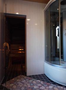 a bathroom with a tub and a sink in a room at Soo Rendimaja in Võru