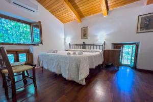 a bedroom with a bed with a table and chairs at Feudo Tudia in Landro