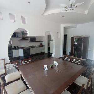 a dining room with a table and a kitchen at Private Luxury Villa - Issyk Kul in Cholpon-Ata