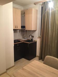 a small kitchen with a sink and a stove at MODERN Apartment In Yerevan,Chekhov Street,New Building in Yerevan