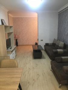 a living room with a couch and a table at MODERN Apartment In Yerevan,Chekhov Street,New Building in Yerevan