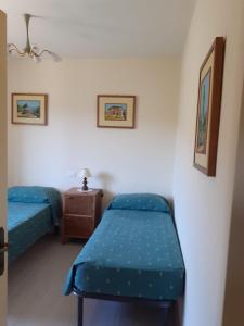 a room with two beds and a table in it at Costa del sole 42 in Cetona