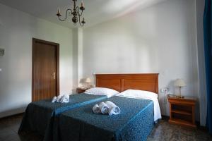Postel nebo postele na pokoji v ubytování Hotel Napoleon