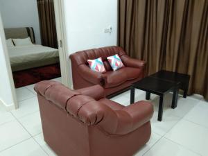 a living room with a couch and a chair and a table at PINTARMAN EXPRESS @ MIRI TIMES SQUARE in Miri