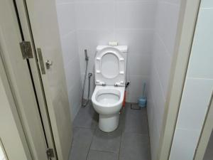 a bathroom with a toilet with the lid up at PINTARMAN EXPRESS @ MIRI TIMES SQUARE in Miri