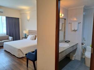 a hotel room with a bed and a sink at Liberty 2 Hotel in Ho Chi Minh City