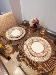 a table with two plates on top of it at Suite M - 1 Bedroom Condo at Azure Residences in Manila