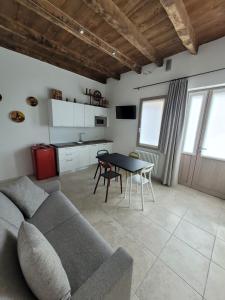 a living room with a couch and a table at Ca’ Marinella in Combai +13 photos