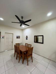 a dining room with a table and a ceiling fan at Magnolia homestay 2 