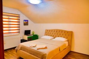 a bedroom with a bed with two towels on it at Vila NERA in Bihać +88 photos