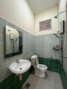 a bathroom with a toilet and a sink at Magnolia homestay 2 