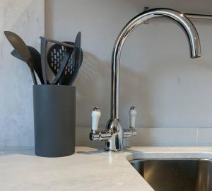 a kitchen counter with a knife block next to a sink at Studio at Church House in Bideford